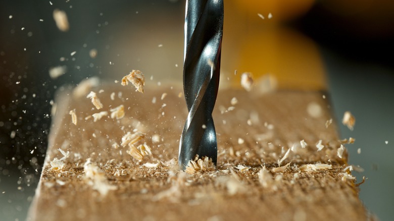 drill bit going through wood