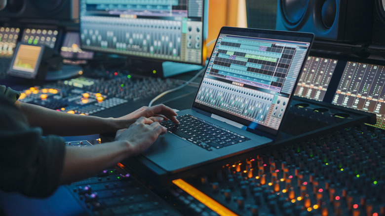 Music producer uses studio laptop