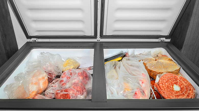 A shot of bagged frozen food inside a chest freezer