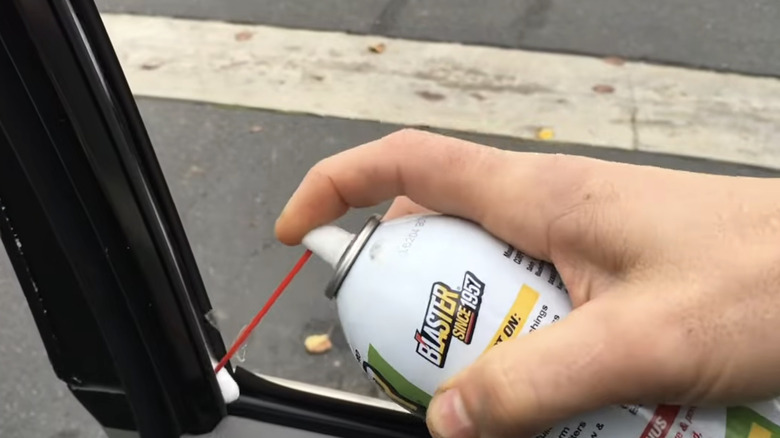 A person using automotive sealant