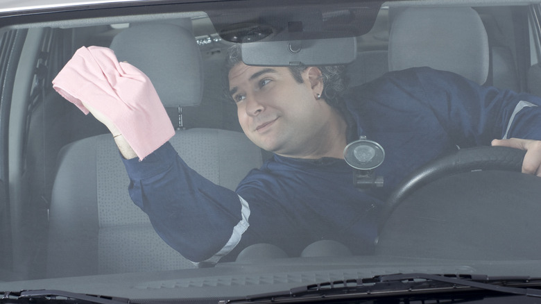 A man washing a car interior