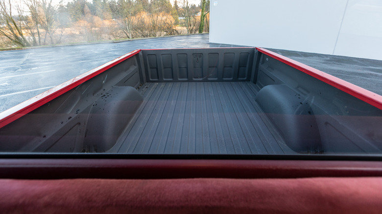 A view of a pickup truck bed from the cab.