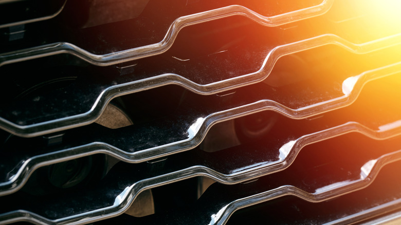 Picture of sunlight shining on the front grille of a car