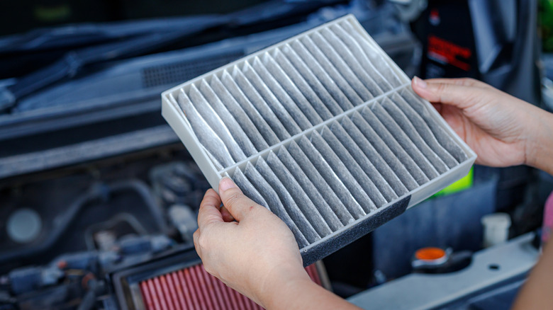 Mechanic holding dirty air filter