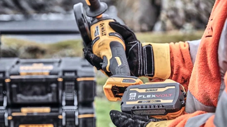 Person removing FlexVolt battery pack from DeWalt device