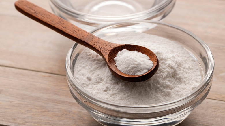Spoon in small bowl of baking soda.
