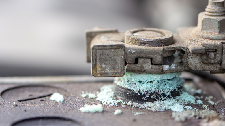 Accumulated corrosion on a battery terminal.
