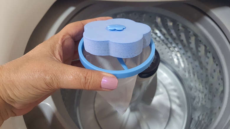 person holding cone shaped lint filter