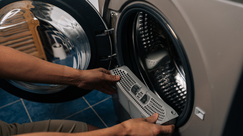 person holding lint filter