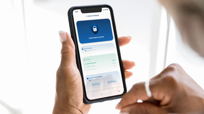 Person checking smartphone security app