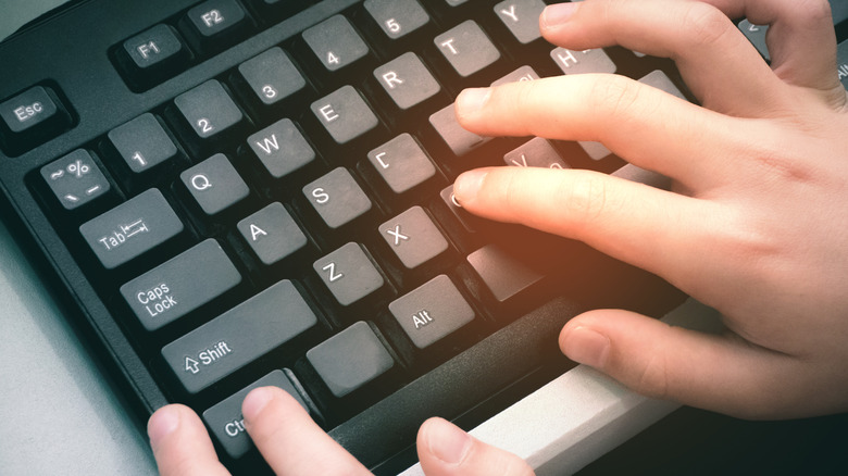 hands on computer keyboard