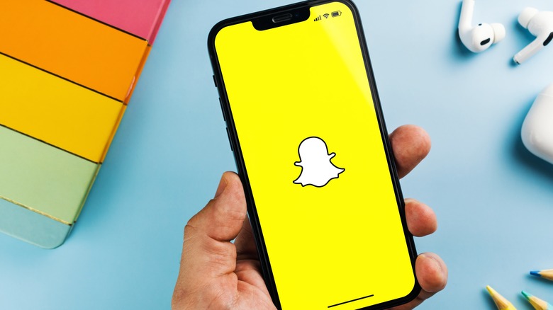 man using snapchat on iphone