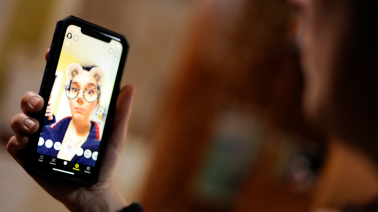 woman using snapchat filter