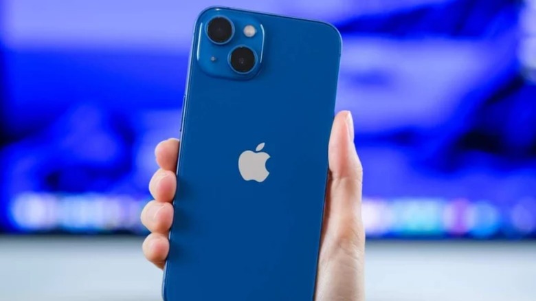 Hand holding a blue iPhone