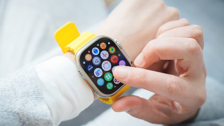 hand tapping Apple Watch app icon