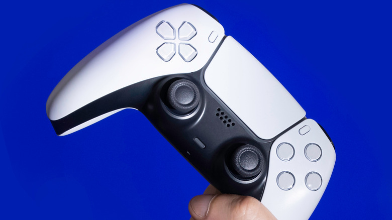 A hand holding the PS5 DualSense wireless controller