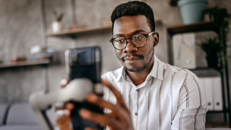 person preparing to film with smartphone