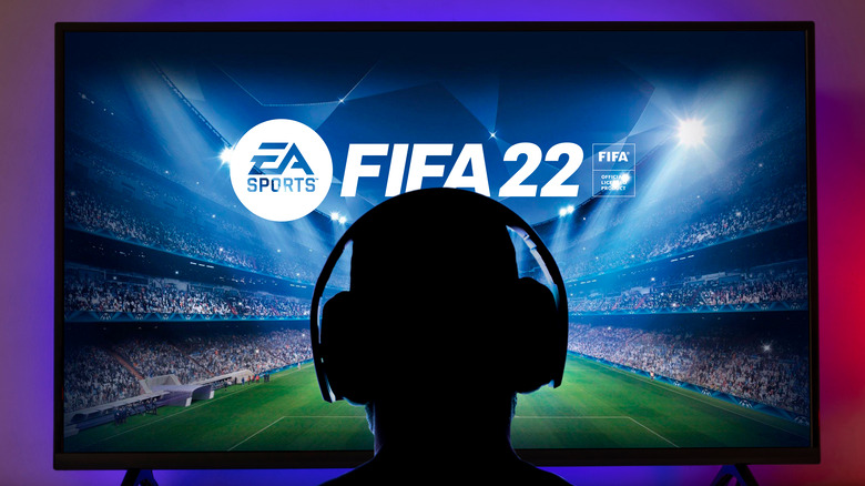 Person with headset playing FIFA22
