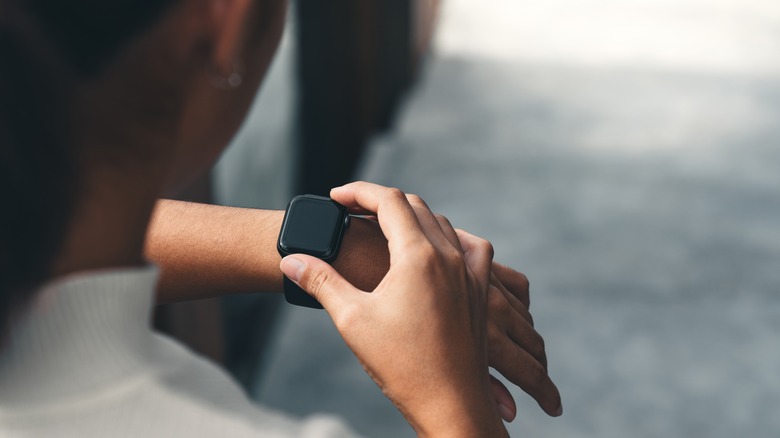 woman using smart watch