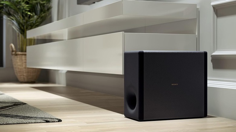 Sony SA-SW3 subwoofer on floor by white shelves