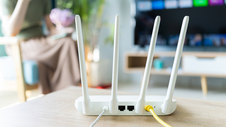 White router with TV in the background