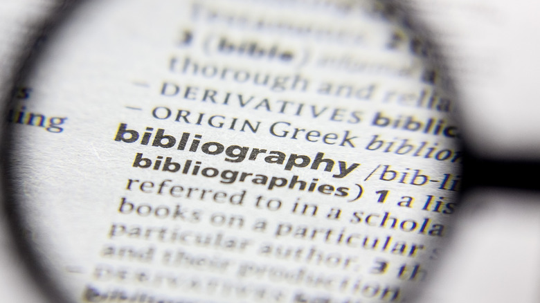 magnifying glass focused on bibliography in the dictionary, also exemplifying a hanging indent