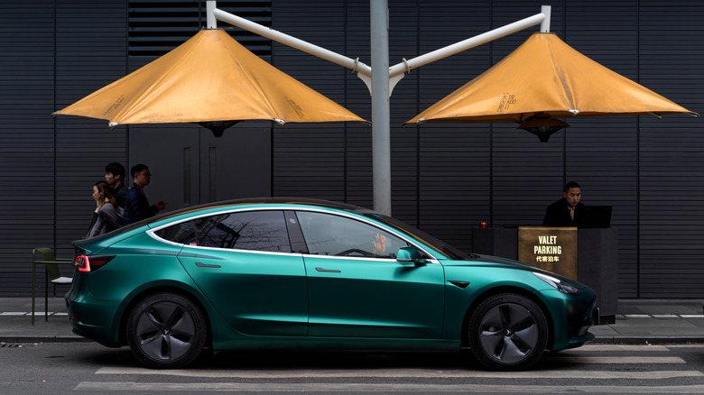 tesla parked at valet stand