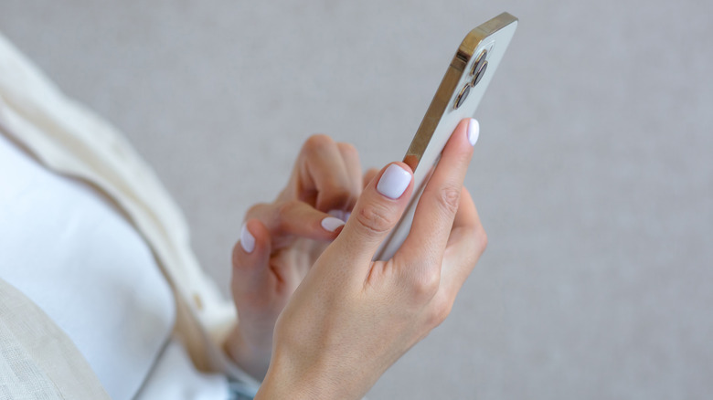 woman tapping on an iPhone