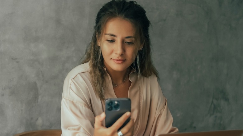 woman looking at iphone