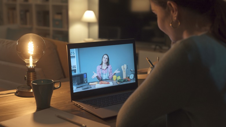 person watching video on a laptop