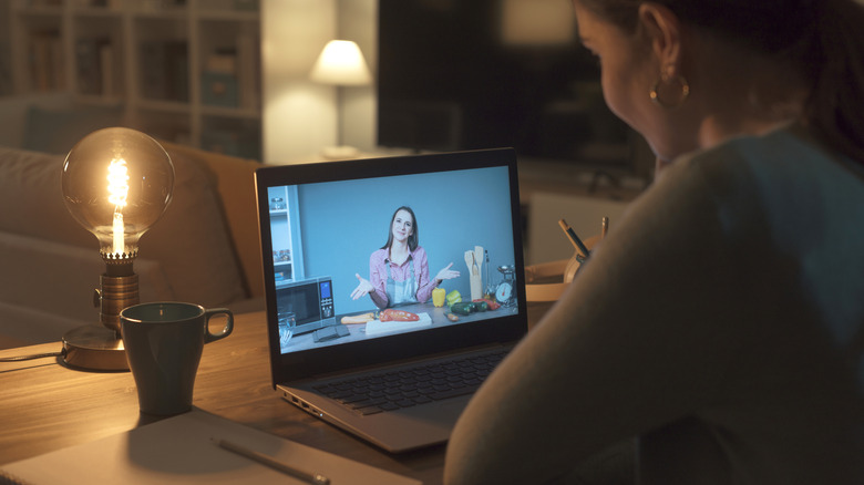 person watching video on a laptop
