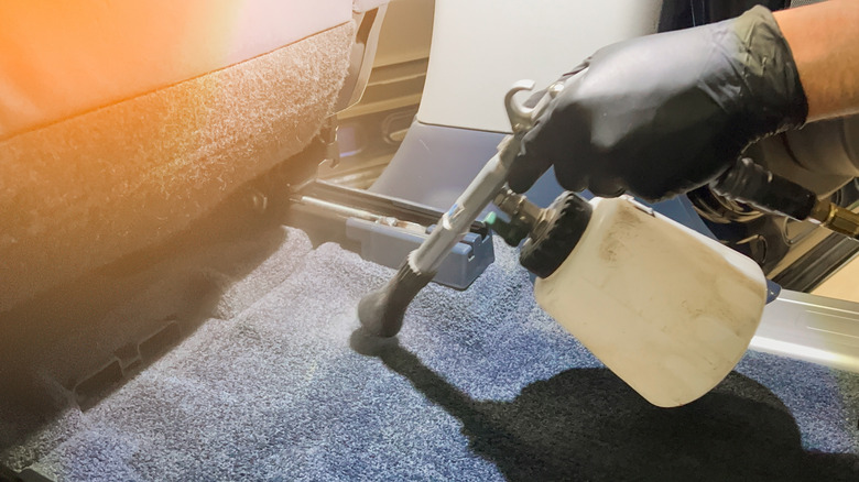 Person detailing interior of car