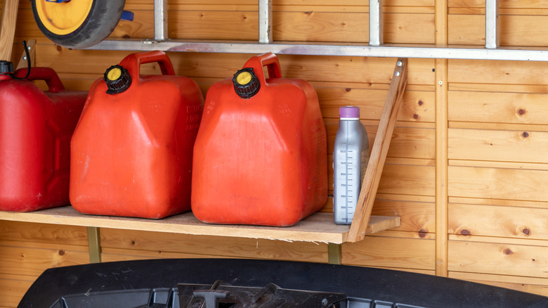 Garage corner with three red plastic fuel cans