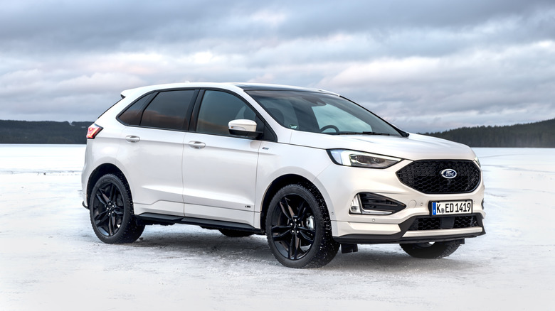 A white Ford Edge ST-Line on some snow, front 3/4 view