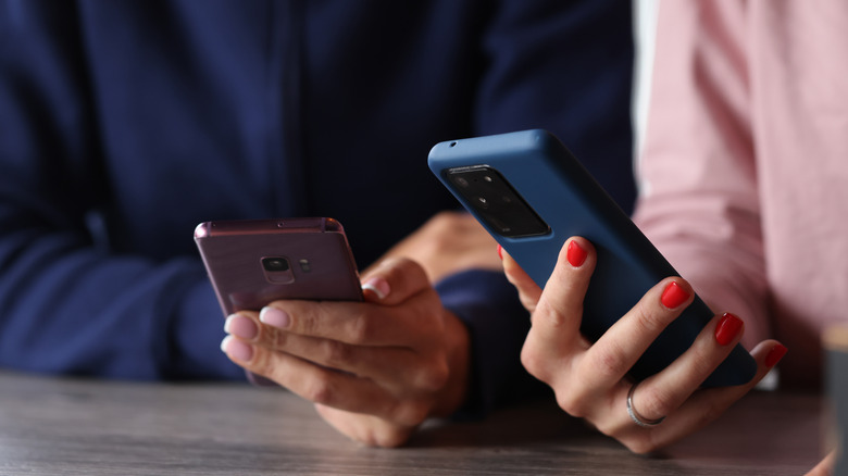 two women using android phones