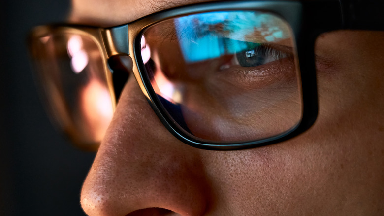 computer in reflection of glasses