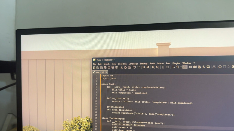 Monitor showing Notepad++ in dark mode