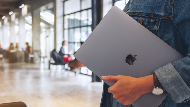 Person holding MacBook