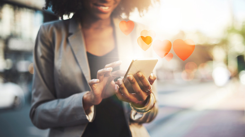 woman using phone with hearts