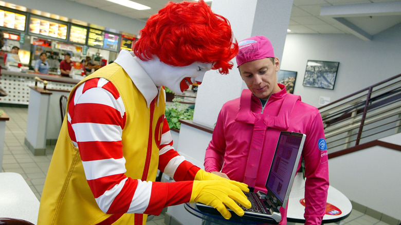 Ronald McDonald using laptop at McDonald's