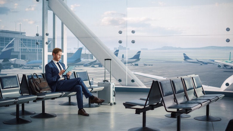 Man using tablet at airport terminal