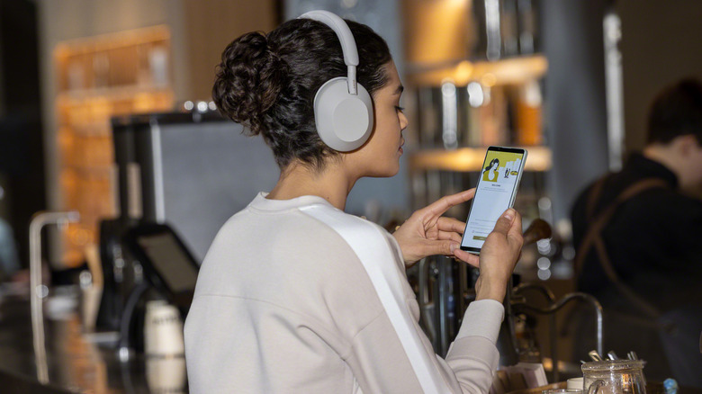 Person wearing Sony WH-1000XM5 headphones