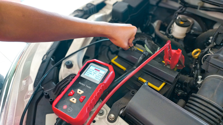 Person testing car battery