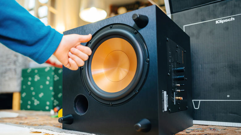 A Klipsch subwoofer with a copper driver is displayed during unboxing