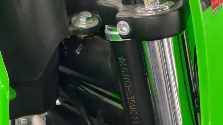 close up view of a motorcycle VIN on a green dirt bike