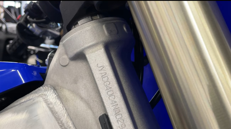 Blue dirt bike headstock with VIN engraved
