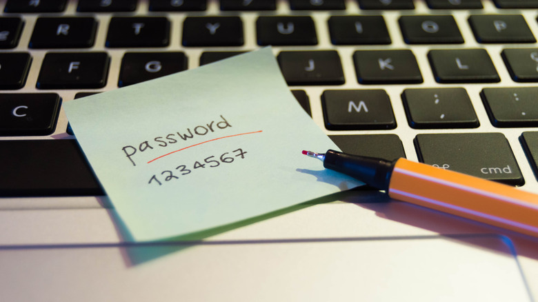 password on paper atop macbook