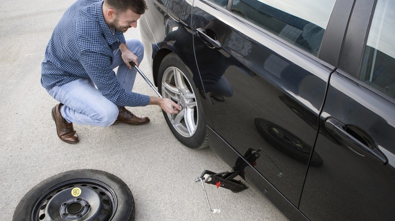 A person fixing a flat tire