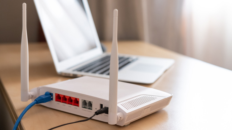 WiFi router next to laptop
