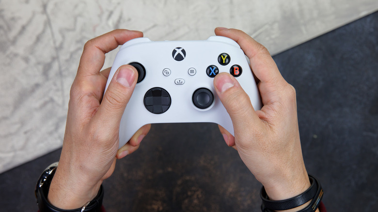 Person holding xbox controller